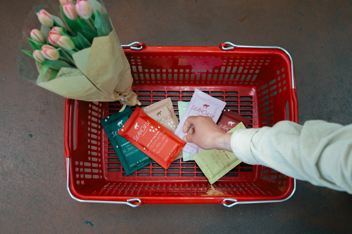 individual placing Seahorse Chocolate bars in shopping basket 