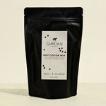 Black packaging of Seahorse Hot Cocoa Mix on a beige background