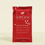 Red packaging of Seahorse Chocolate on a beige background