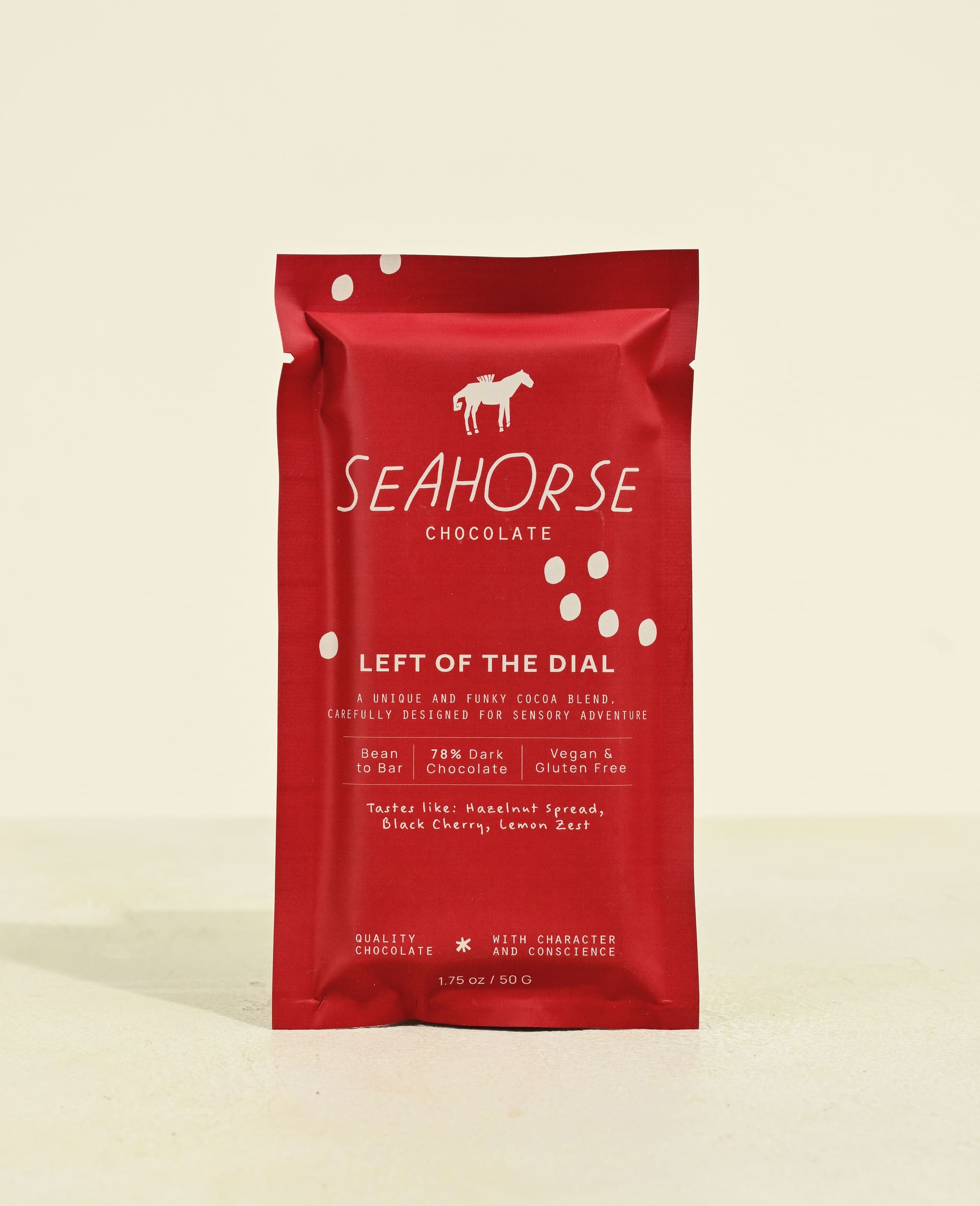 Red packaging of Seahorse Chocolate on a beige background