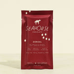 Red packaging of Seahorse Chocolate on a beige background