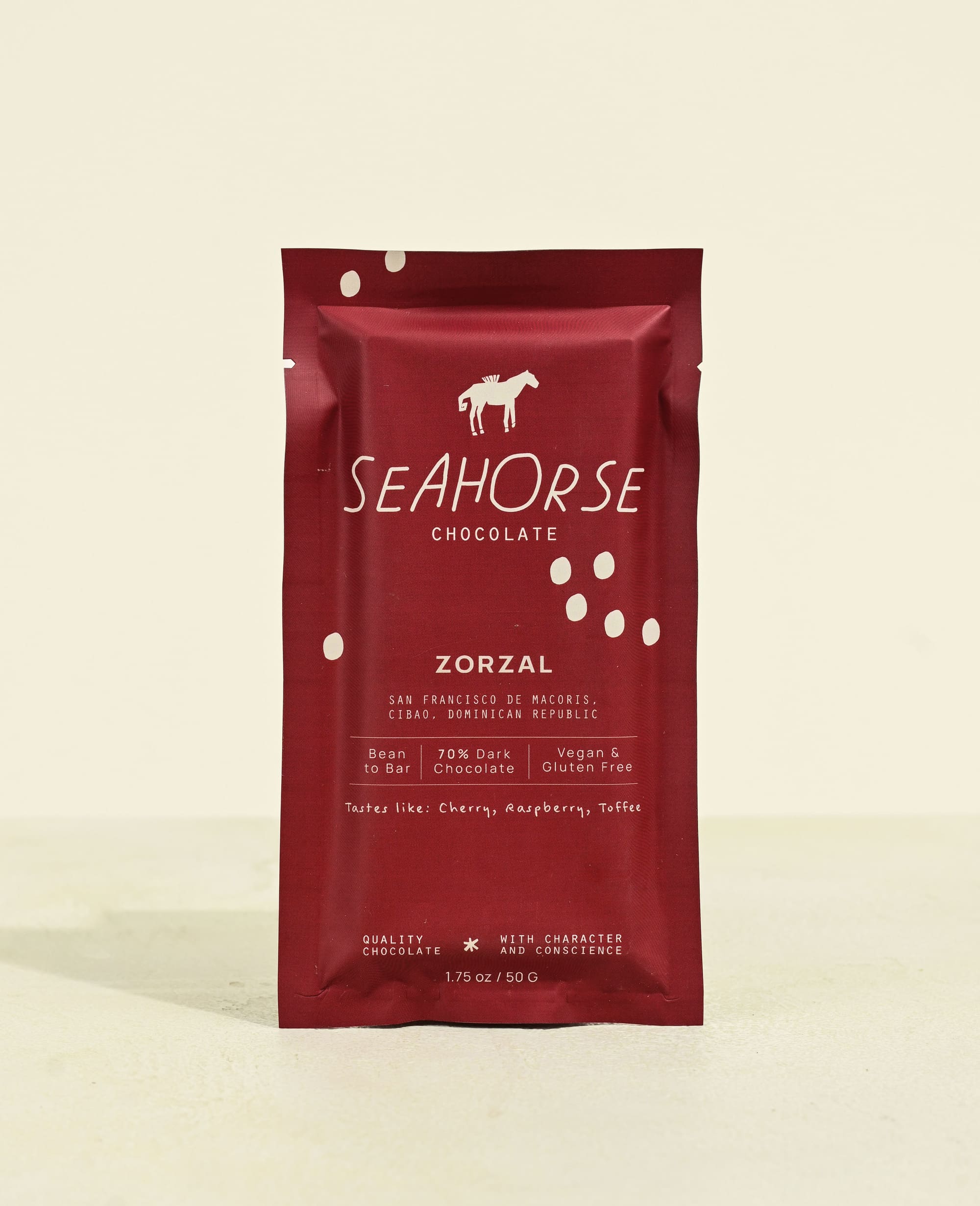 Red packaging of Seahorse Chocolate on a beige background